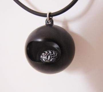 Pendant Ebony with Loose rolling Zebra shell in resin sphere : $150